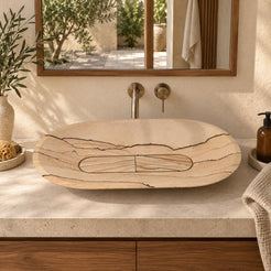 Selia sandstone oval vessel sink from the front in a warm walnut bathroom