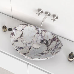 Selva Calacatta marble vessel sink in an elevated countertop view