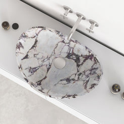 Selva Calacatta marble vessel sink showing the marble interior, rim and drain area