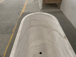 Serena BT-105A Ivory Cloud Marble bathtub, original product detail; source photograph reframed without changing the stone, rim or silhouette