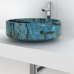 Side lifestyle view of the Shadi Danube Blue Quartzite bowl showing its curved underside and blue markings