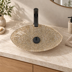 Sikota Sicilia Stone Vessel Sink, centered basin on a warm stone countertop in a bathroom setting