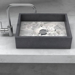 Front view of the Simta rectangular vessel sink with dark granite walls and a veined Carnico marble basin on a stone vanity