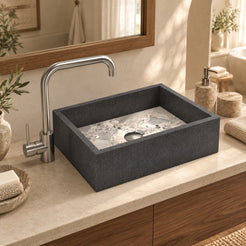 Simta Granite and Carnico Marble vessel sink from above in a sunlit walnut bathroom