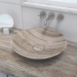 Close overhead view of the Sadika travertine sink bowl and circular drain