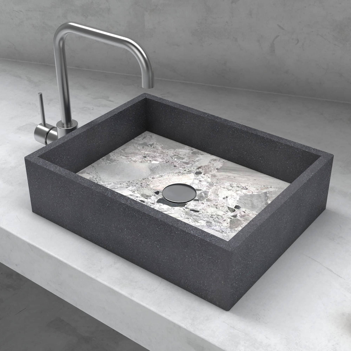 Elevated view of the Simta vessel sink showing its rectangular granite rim and marble basin