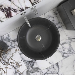 Top view of the Pamala black Portoro marble sink showing the circular bowl and drain