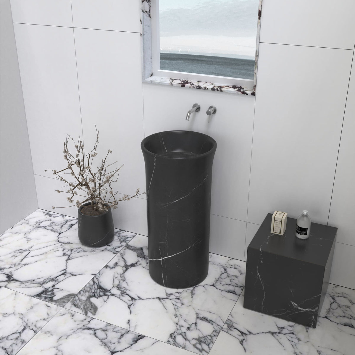 Pamala black marble pedestal sink in a bathroom with a veined stone floor