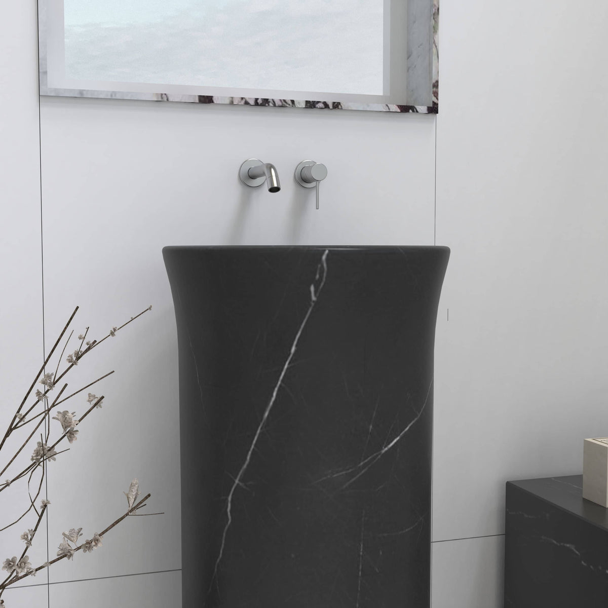 Close view of the Pamala Portoro marble pedestal sink showing pale veining across its black surface
