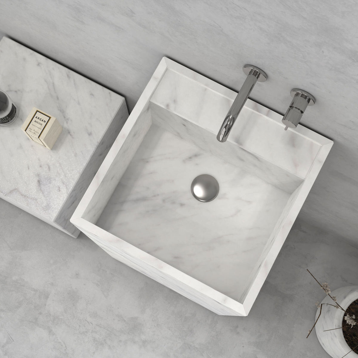 Top view of the Panini Carrara marble sink showing the square bowl and drain