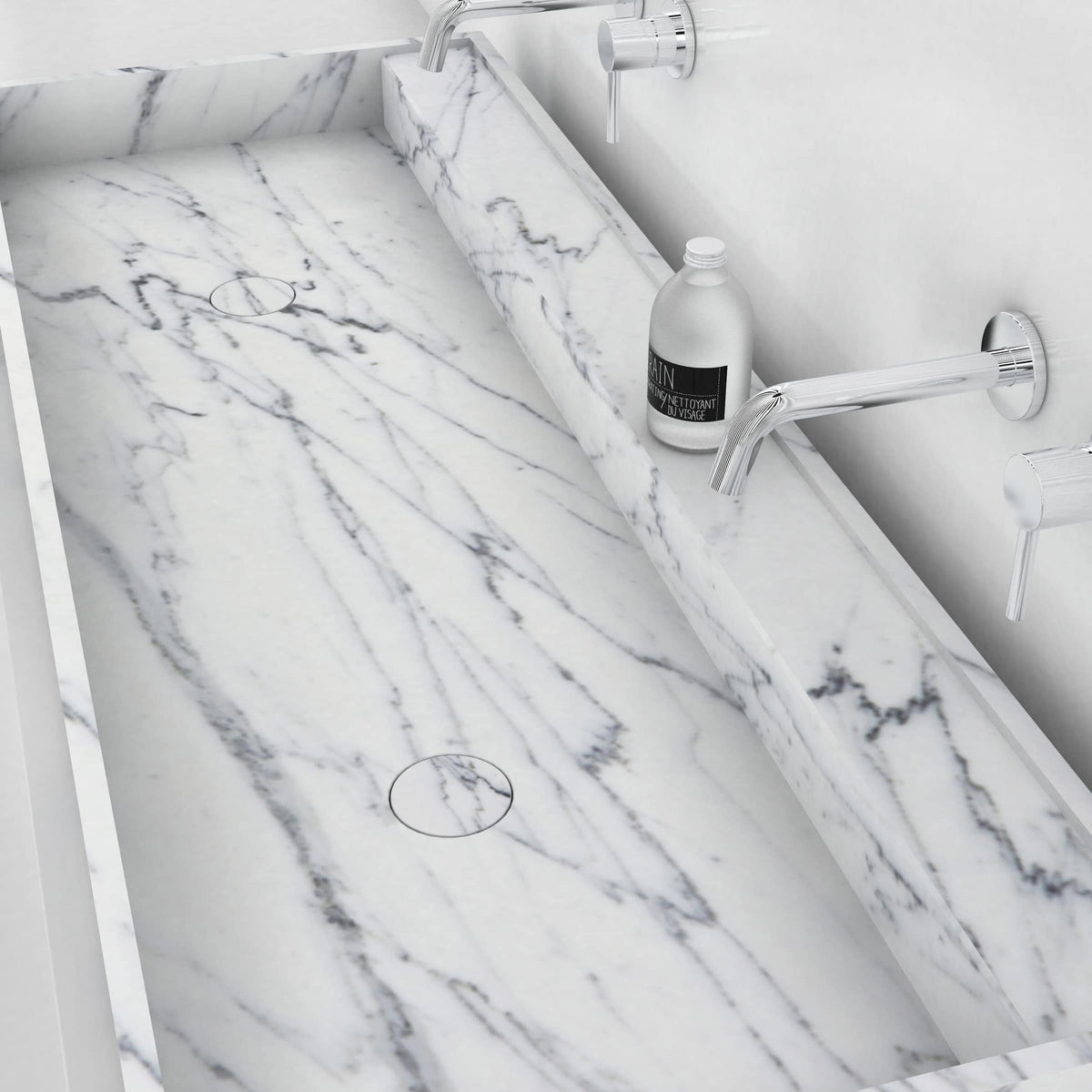 Close view of the Tahira Carrara marble trough basin showing natural veining and a drain