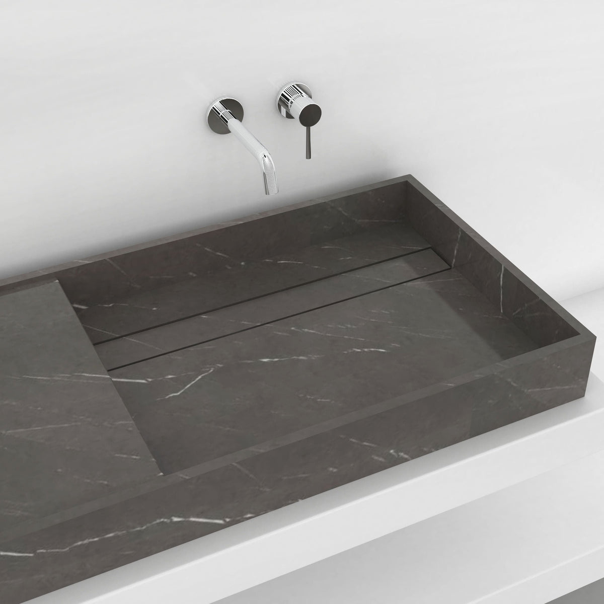 Close view of the Tavira Perlato marble basin showing its sloped interior and subtle veining