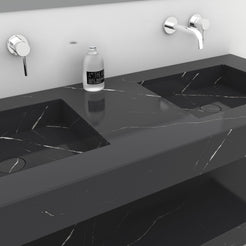 Detail of the Taipa Portoro marble double sink showing the stone surface between the basins