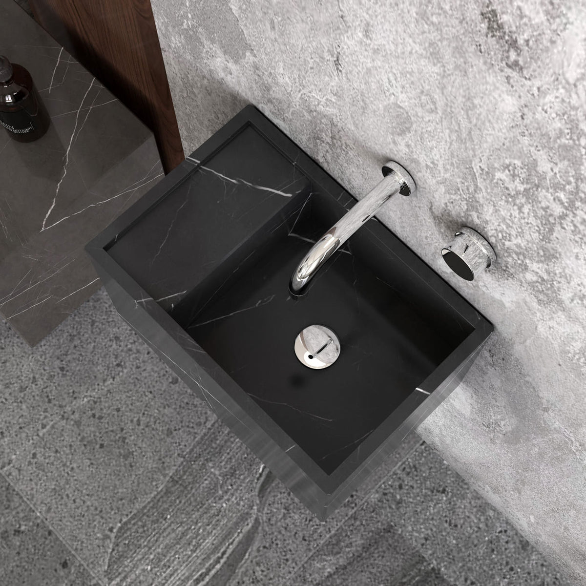 Top view of the Tilika Portoro marble basin below a wall-mounted faucet