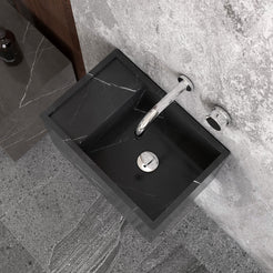 Top view of the Tilika Portoro marble basin below a wall-mounted faucet