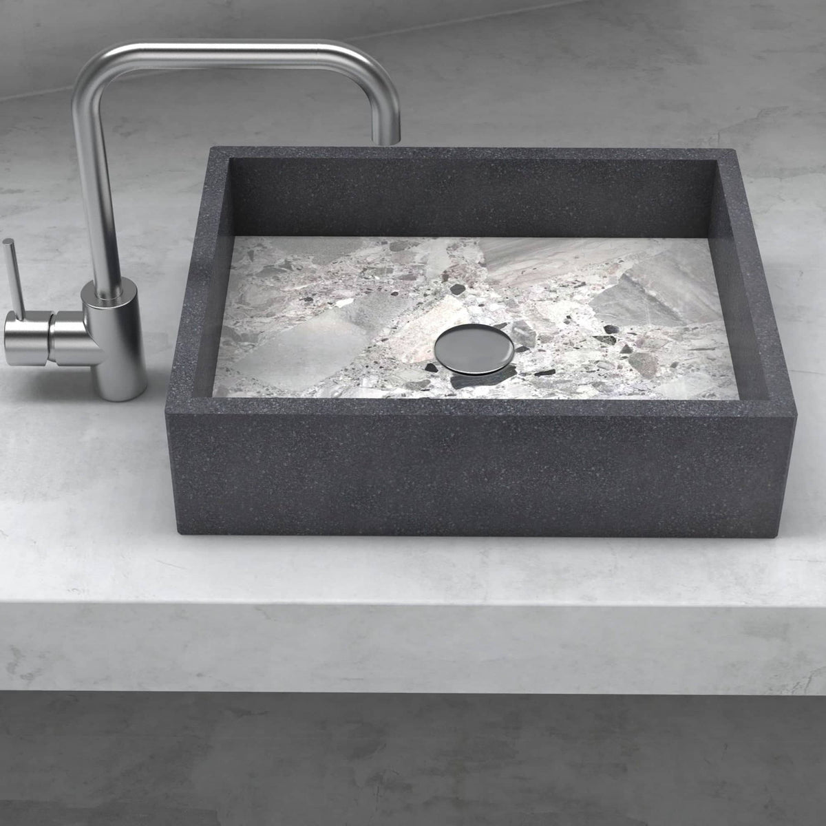 Front view of the Simta rectangular vessel sink with dark granite walls and a veined Carnico marble basin on a stone vanity