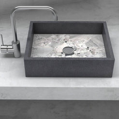 Front view of the Simta rectangular vessel sink with dark granite walls and a veined Carnico marble basin on a stone vanity