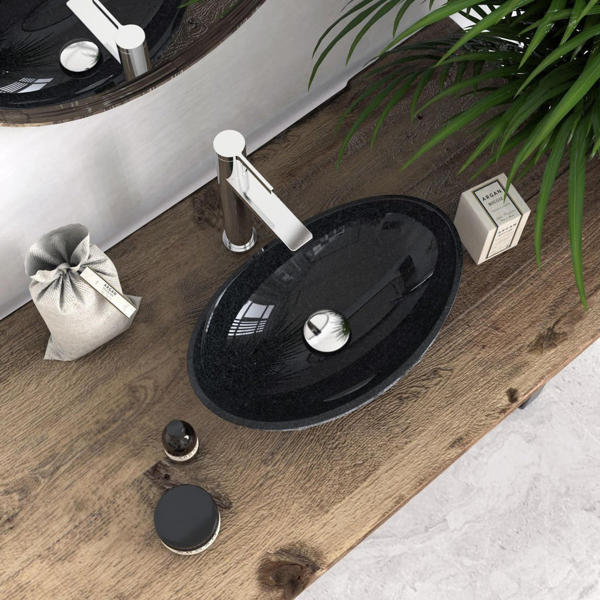 Overhead lifestyle view of the Soraya oval Neroco stone sink on a wooden vanity, showing the dark interior and circular drain