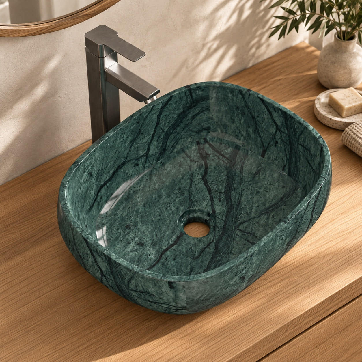 Sabiya rounded Tofino green marble bowl on an oak vanity, open drain