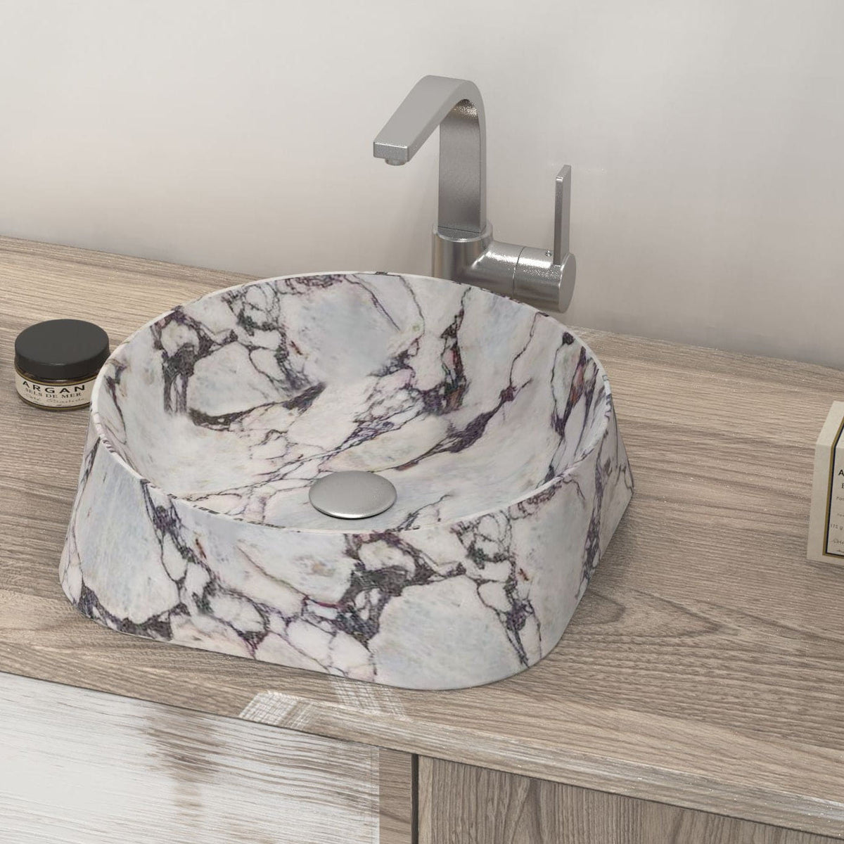 Safira soft triangular Calacatta marble basin on a wood vanity, oblique view