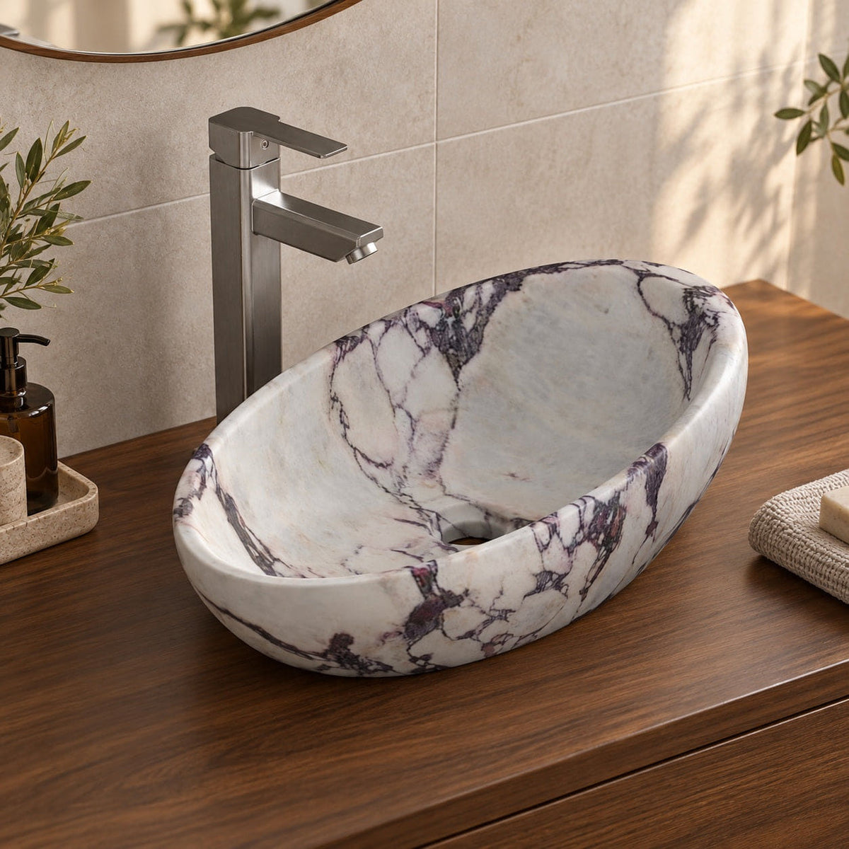Selema Calacatta marble vessel sink, asymmetric oval bowl, on a countertop, hero lifestyle view