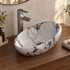 Selema Calacatta marble vessel sink, asymmetric oval bowl, on a countertop, hero lifestyle view