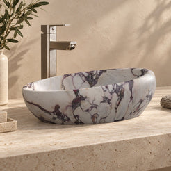 Selema Calacatta marble vessel sink, asymmetric oval bowl, on a countertop from a second angle