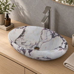 Selema Calacatta marble vessel sink, asymmetric oval bowl, in an overhead or alternate countertop setting