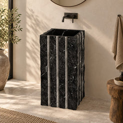 Pablo Portoro Black Marble Pedestal Sink — complete rectangular pedestal with vertical details in a warm bathroom
