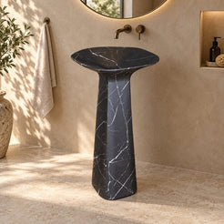 Polona Portoro Black Marble Pedestal Sink — complete rounded-rectangular basin and pedestal in a warm bathroom