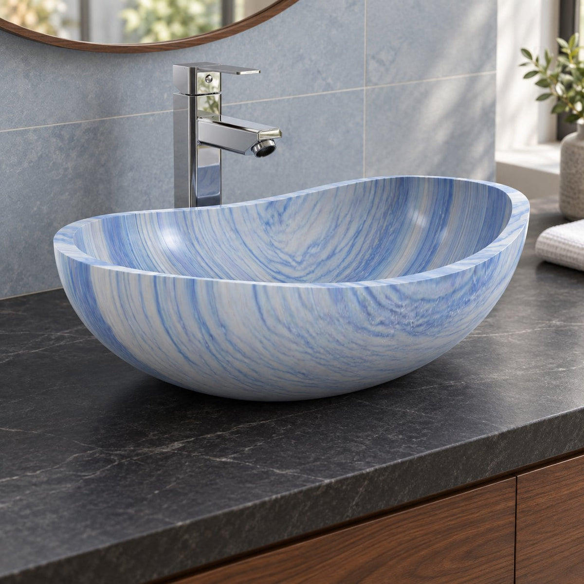 Spirit Azura oval blue quartzite vessel sink on a charcoal counter, opposite angled view showing its thin rim and curved basin