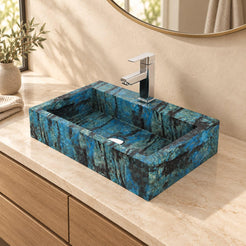 Shafna Danube rectangular blue quartzite vessel sink on a cream counter above an oak vanity, angled bathroom view
