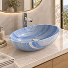 Shabin Azura oval blue quartzite vessel sink on a pale stone counter above an oak vanity, front angled bathroom view