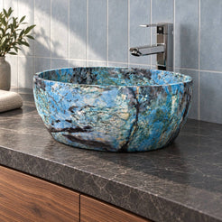 Low bathroom view of the Shaden Danube quartzite vessel sink showing deep curved walls on a charcoal counter