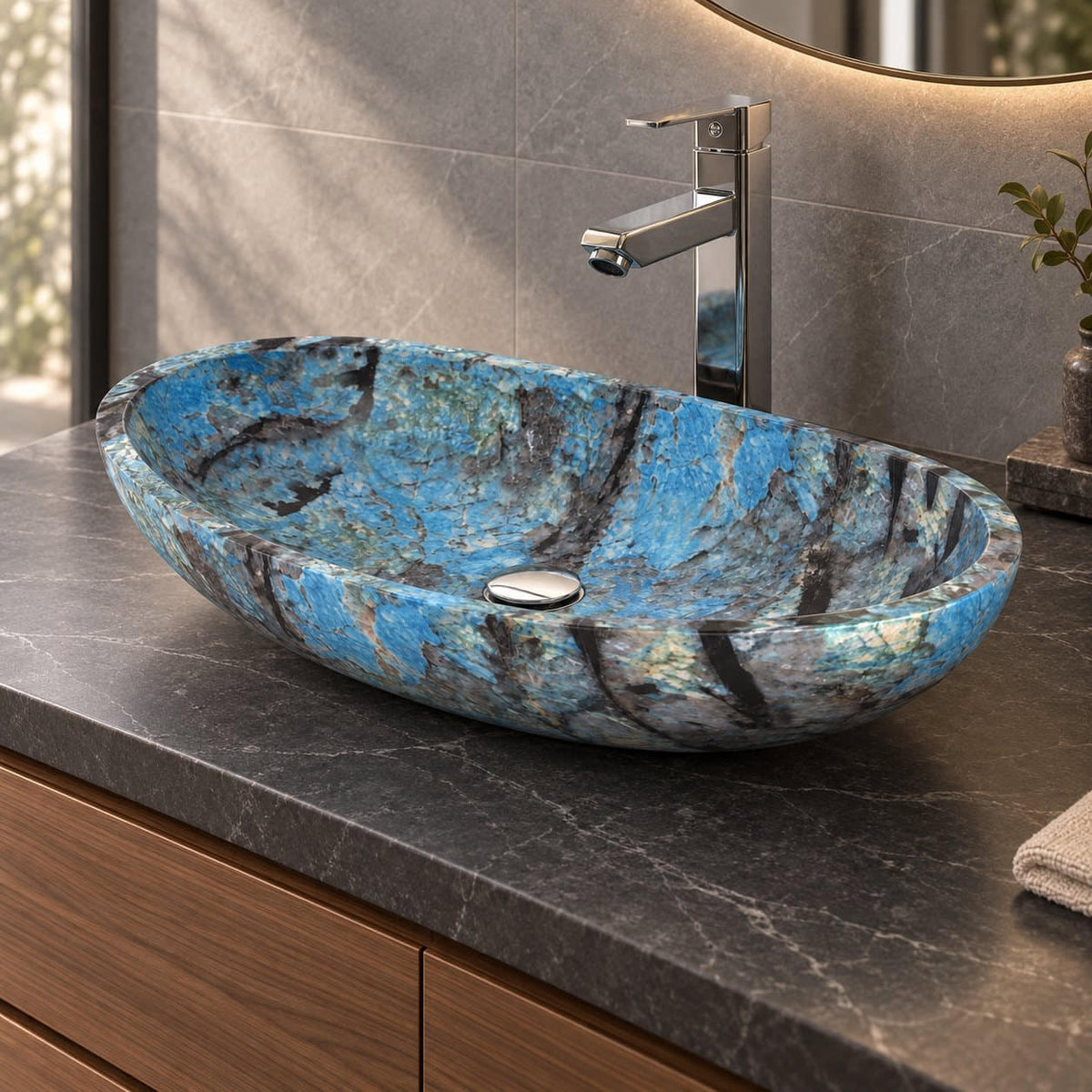 Spirit Danube oval blue quartzite vessel sink on a charcoal counter showing its low curved profile