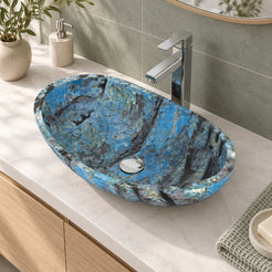 Elevated bathroom view of the Spirit Danube quartzite vessel sink showing its full oval rim, blue-black veining and round drain