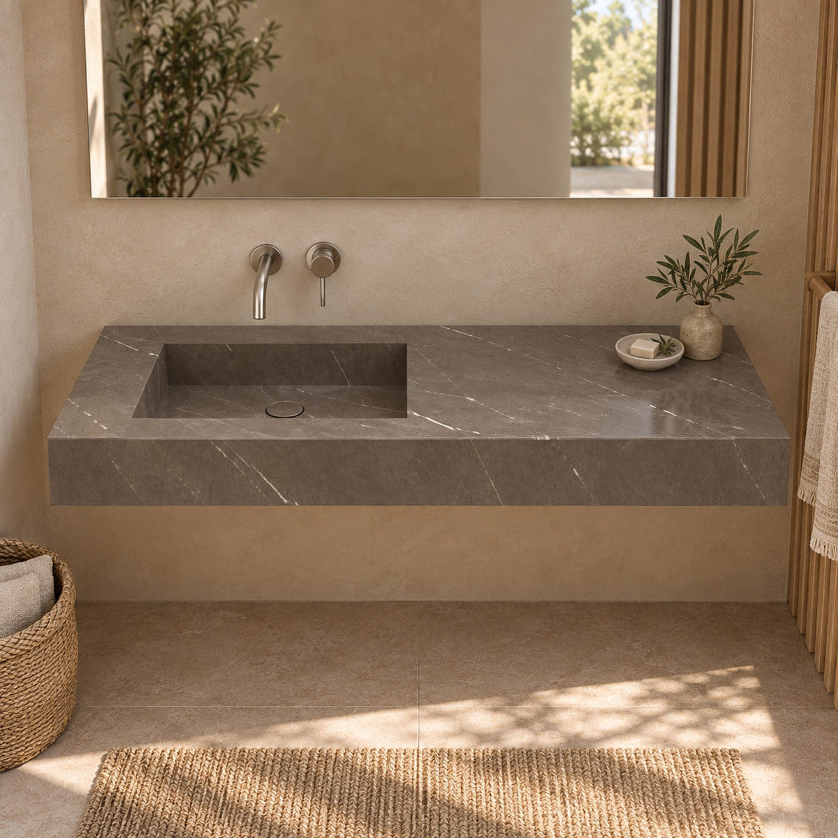 Tacita Perlato marble integrated trough sink shown from the front in a beige and oak bathroom