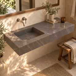 Tacita Perlato marble integrated trough sink from an elevated angle showing the rectangular basin and marble drain cover