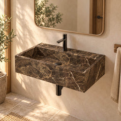 Tiarra Marroca marble wall-mounted sink in a warm ivory and oak bathroom, showing its rectangular basin, black drain and floating profile