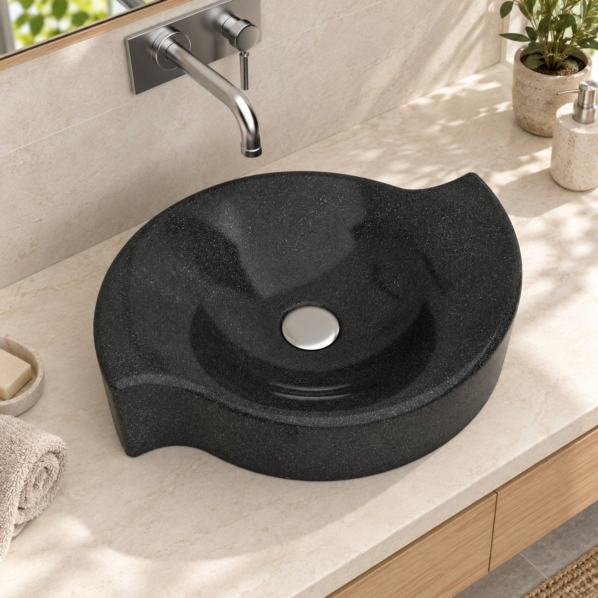 Illustrative high-angle bathroom lifestyle of the Sommer Neroco stone vessel sink with its sculpted rim