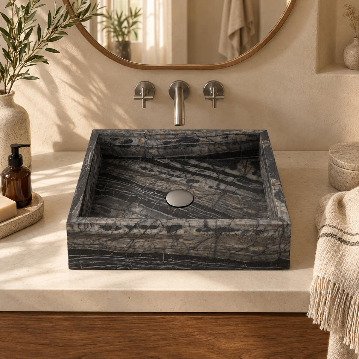 Soovi Perlino Marble square vessel sink in a warm cream and walnut bathroom, with straight thin-edged walls, banded charcoal stone and a silver drain cover.