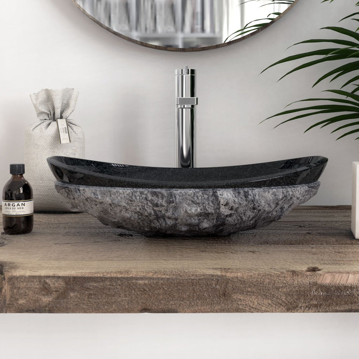 Front profile of the Soraya oval Neroco stone vessel sink showing the hand-chiseled exterior and polished rim