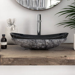 Front profile of the Soraya oval Neroco stone vessel sink showing the hand-chiseled exterior and polished rim