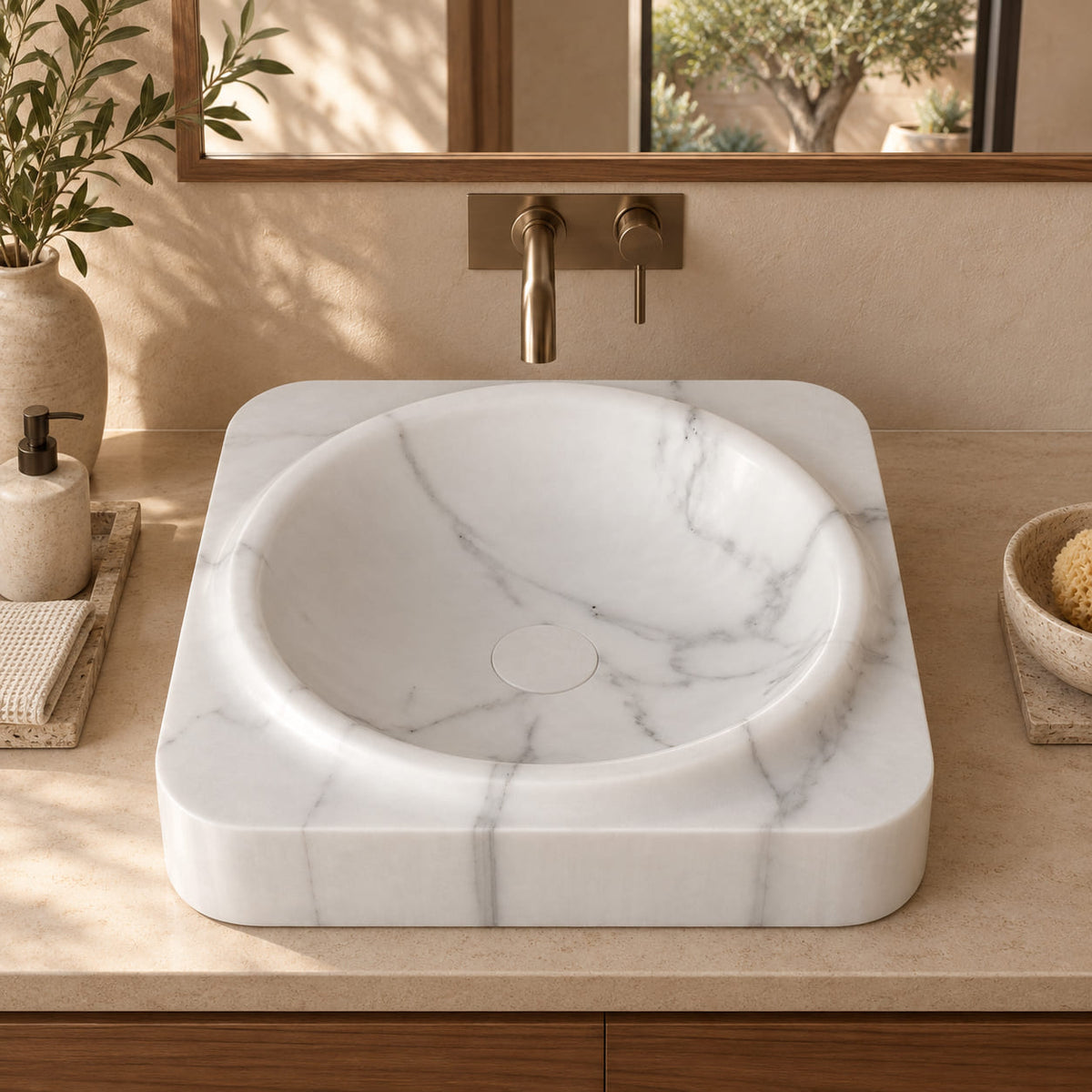Spencer Arabescato Marble rounded-square vessel sink from the front in a warm walnut courtyard bathroom, showing the raised circular rim and white stone drain cover.