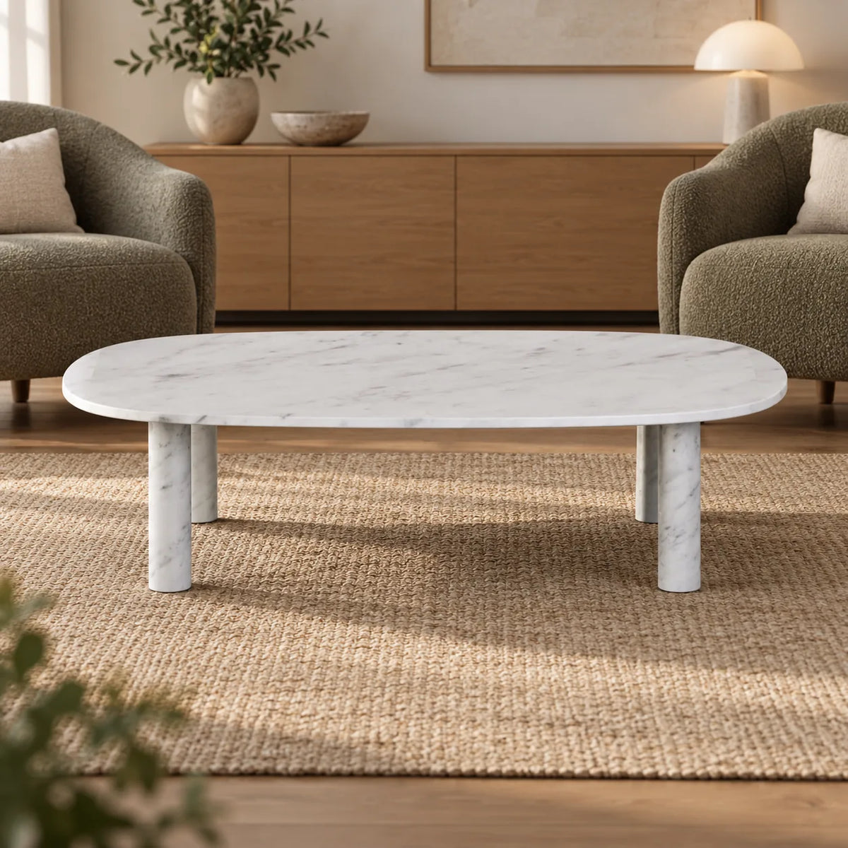 SquareCurve Carrara marble coffee table shown from a low long-side angle in a conversation lounge.