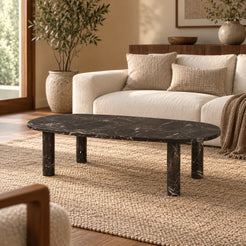 SquareCurve Spanish Dark Emperador marble coffee table with a thin rounded rectangular top and four cylindrical legs in a warm cream-sofa living room.