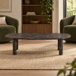 Low front view of the SquareCurve Spanish Dark Emperador marble coffee table in a moss-green-chair reading lounge, showing its thin top and four stone legs.