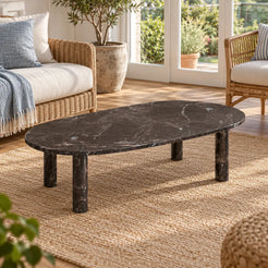 Elevated view of the SquareCurve Spanish Dark Emperador marble coffee table in a garden-facing sunroom, showing its rounded rectangular top and four cylindrical supports.
