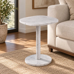 SquareSoft Carrara marble side table with a rounded square top and cylindrical pedestal beside a linen sofa.