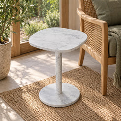 SquareSoft Carrara marble side table viewed from an elevated angle in a garden-facing reading nook.